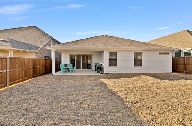 rear view of house featuring a patio and a fenced backyard