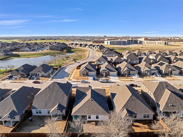 bird's eye view with a residential view and a water view