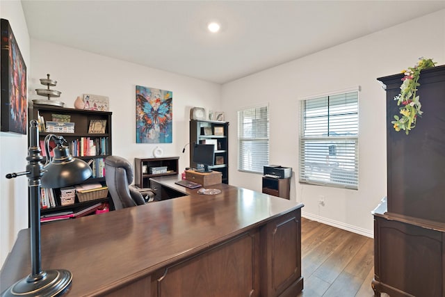 office area featuring dark wood finished floors and baseboards