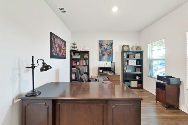 office featuring wood finished floors, visible vents, and baseboards