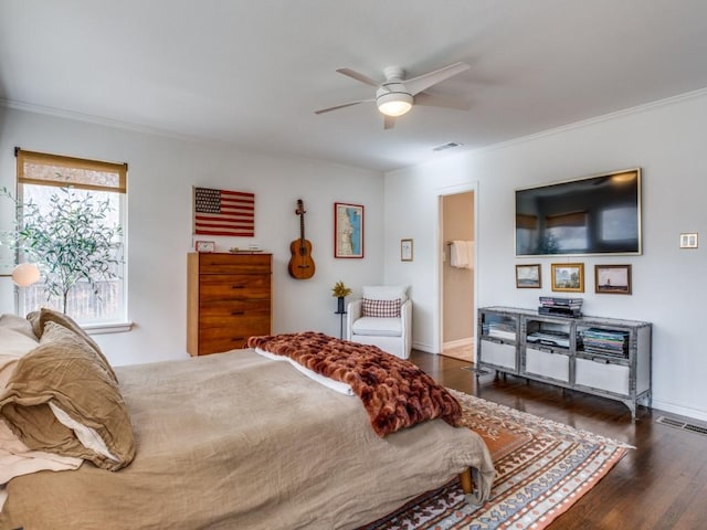 bedroom with visible vents, ornamental molding, and wood finished floors