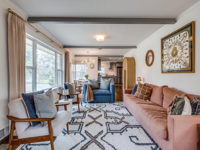 living room with wood finished floors, beamed ceiling, arched walkways, and ornamental molding