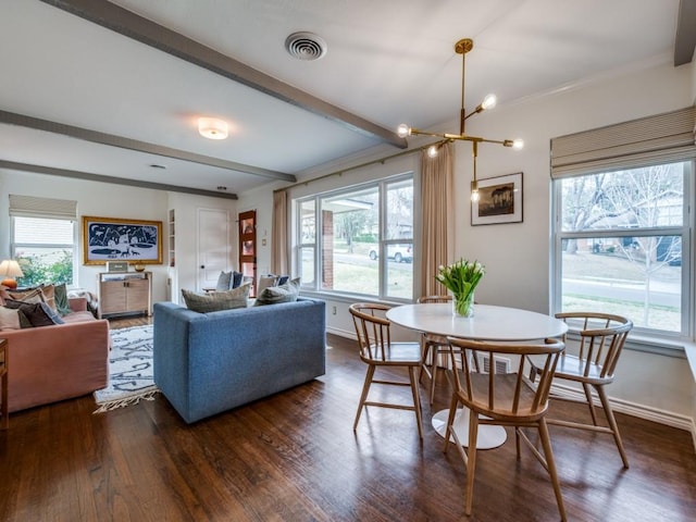 living room featuring beam ceiling, dark wood-style floors, visible vents, and a wealth of natural light