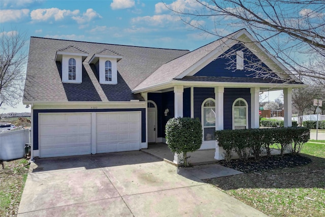 view of front of property with concrete driveway and a shingled roof