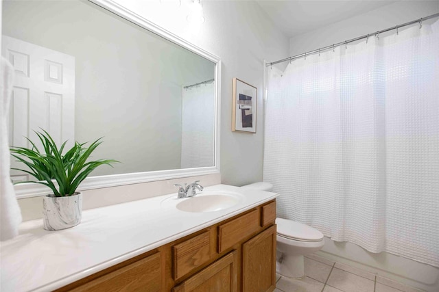 full bath with vanity, tile patterned floors, toilet, and shower / bath combo with shower curtain