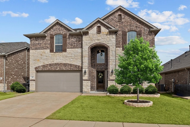 french country home featuring brick siding, stone siding, driveway, and a front lawn