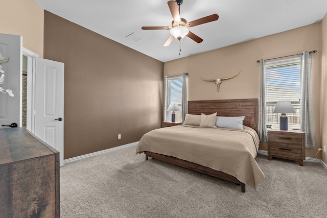 carpeted bedroom featuring visible vents, baseboards, ceiling fan, and vaulted ceiling