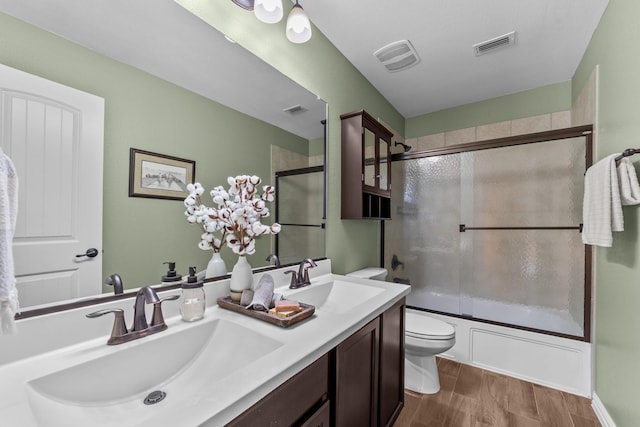 bathroom with a sink, visible vents, and toilet