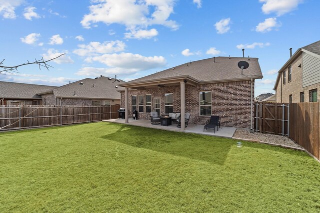 back of house featuring a patio area, brick siding, a fenced backyard, and a lawn