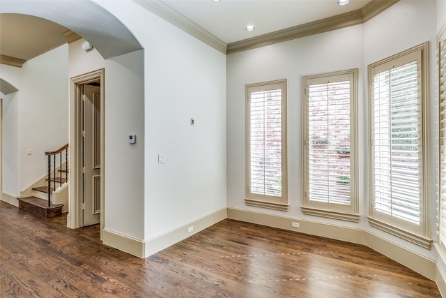 spare room with arched walkways and a healthy amount of sunlight