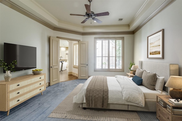 bedroom with visible vents, a raised ceiling, and ornamental molding