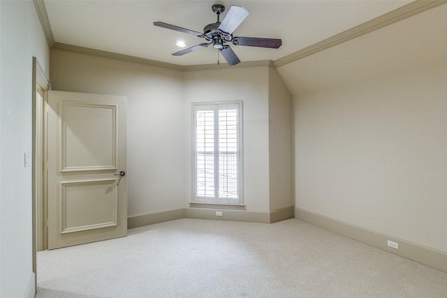 unfurnished room with ceiling fan, baseboards, crown molding, and carpet