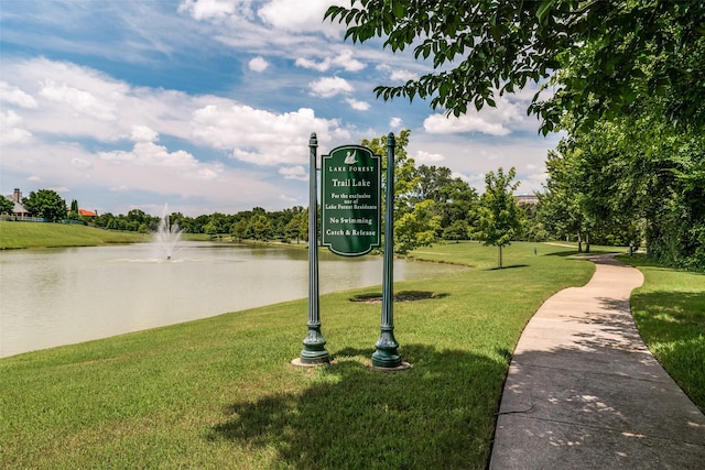 view of home's community with a yard and a water view