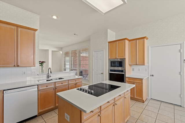 kitchen featuring wallpapered walls, light countertops, light tile patterned floors, appliances with stainless steel finishes, and a sink