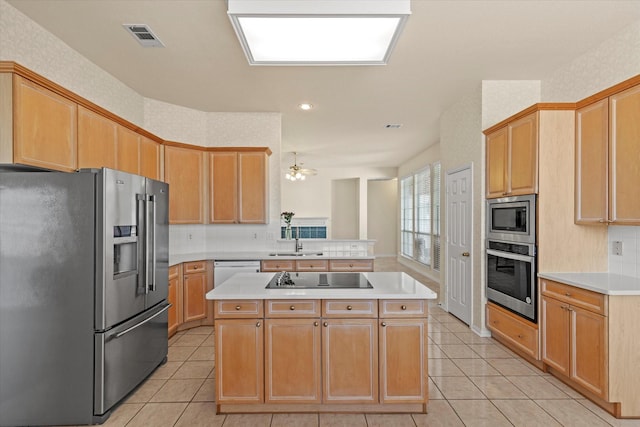 kitchen with light tile patterned floors, visible vents, a sink, appliances with stainless steel finishes, and a center island