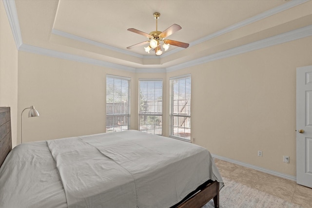 bedroom with a raised ceiling, baseboards, and ornamental molding