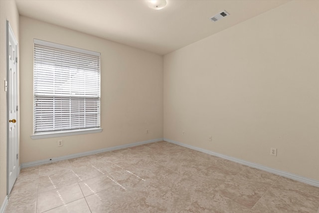 unfurnished room featuring visible vents and baseboards