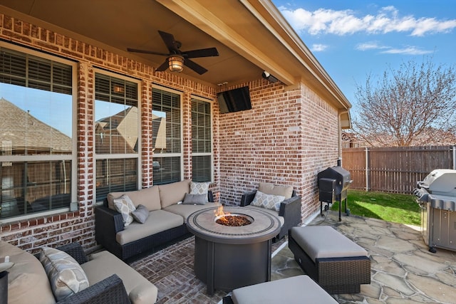 view of patio / terrace with a grill, an outdoor living space with a fire pit, a ceiling fan, and fence