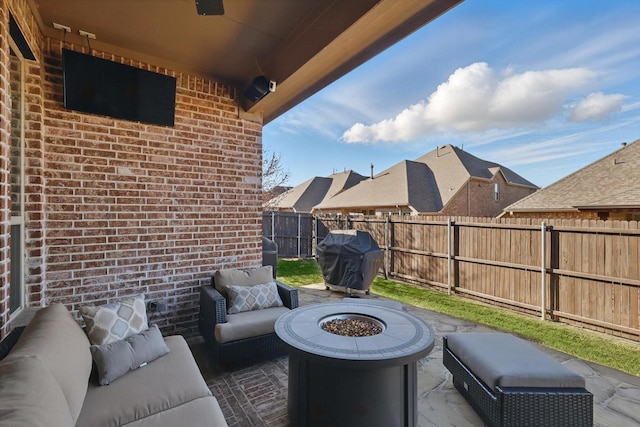 view of patio / terrace featuring area for grilling, an outdoor living space with a fire pit, and fence