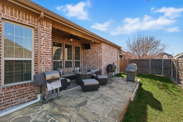 view of patio / terrace featuring area for grilling, a fenced backyard, and ceiling fan