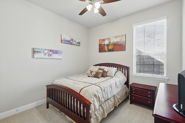 carpeted bedroom with baseboards and ceiling fan