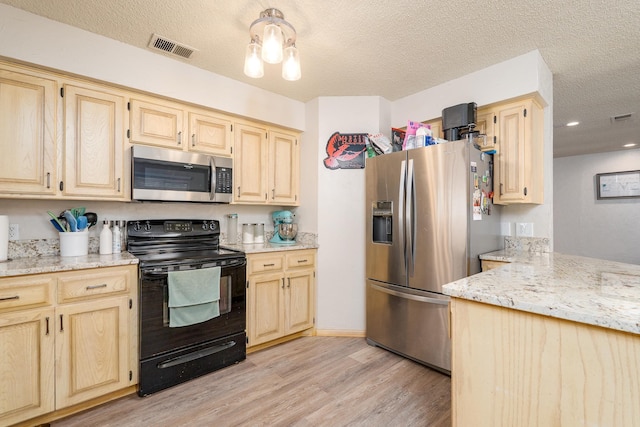 kitchen with stainless steel appliances, visible vents, and light brown cabinetry