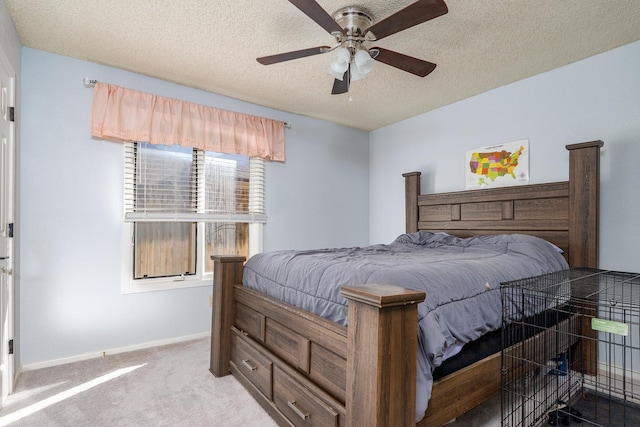 carpeted bedroom featuring baseboards, a textured ceiling, and ceiling fan