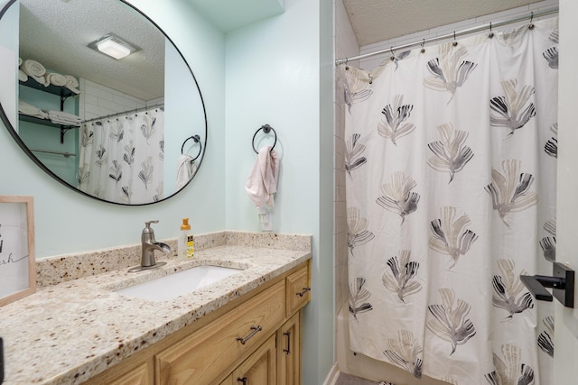 bathroom featuring visible vents, a textured ceiling, and vanity