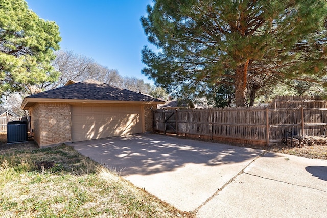 exterior space featuring central AC and fence