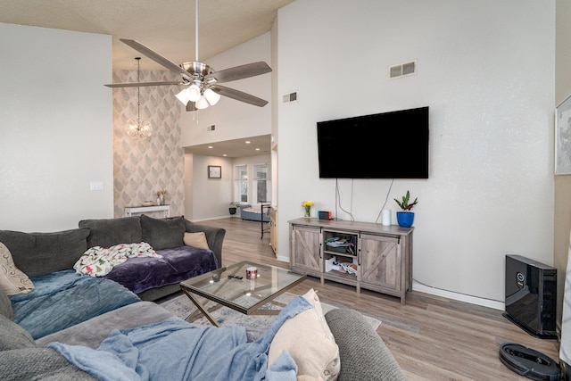 living area featuring visible vents, wood finished floors, and a ceiling fan