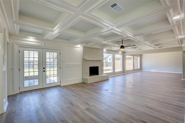 unfurnished living room with visible vents, wood finished floors, beam ceiling, french doors, and a ceiling fan