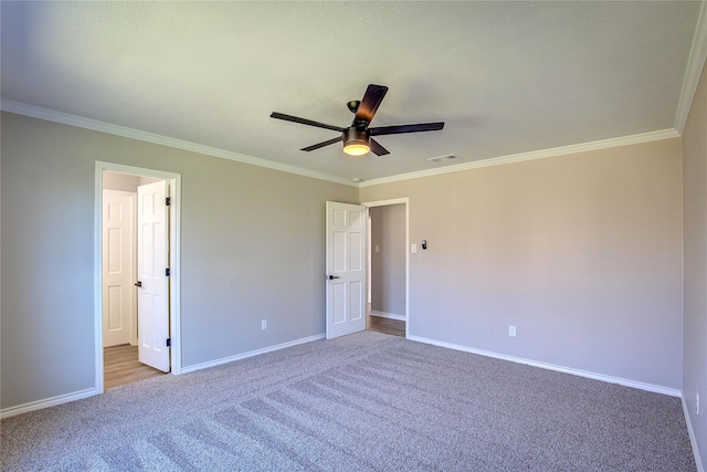 unfurnished bedroom featuring carpet floors, ornamental molding, and baseboards