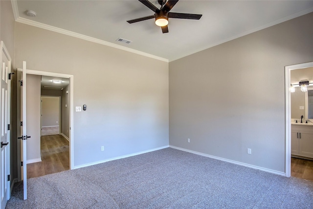 unfurnished bedroom featuring visible vents, carpet flooring, a sink, and ornamental molding
