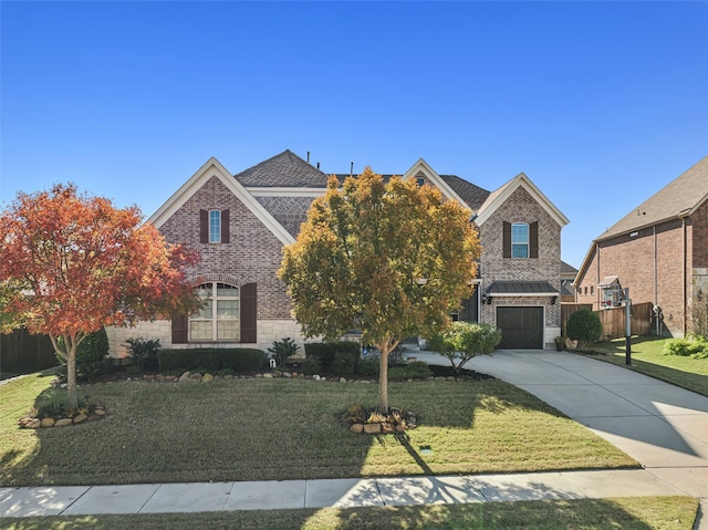 view of front facade featuring brick siding, driveway, and a front yard