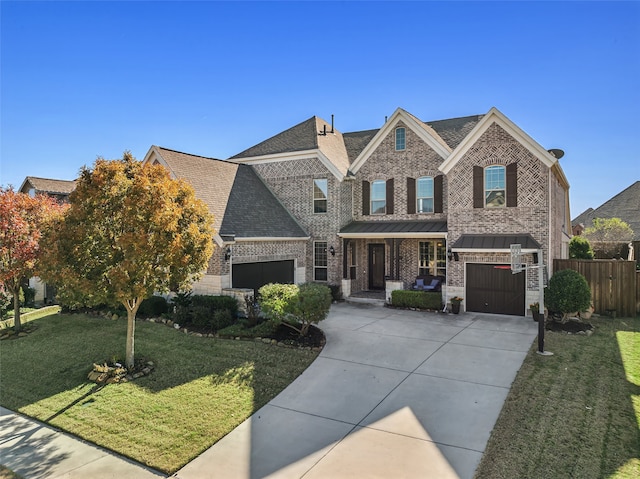 view of front of home featuring brick siding, fence, concrete driveway, a front yard, and a garage