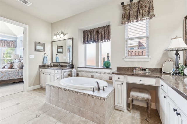 bathroom featuring vanity, visible vents, ensuite bath, tile patterned flooring, and a bath