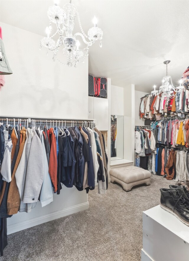 spacious closet featuring carpet flooring and a chandelier