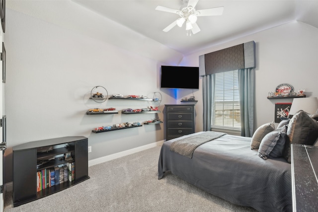 carpeted bedroom featuring lofted ceiling, baseboards, and ceiling fan