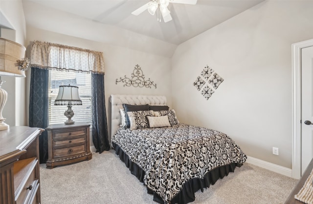 bedroom with baseboards, light colored carpet, lofted ceiling, and a ceiling fan