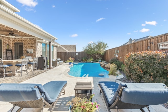 view of swimming pool featuring a patio area, a fenced backyard, a fenced in pool, and ceiling fan