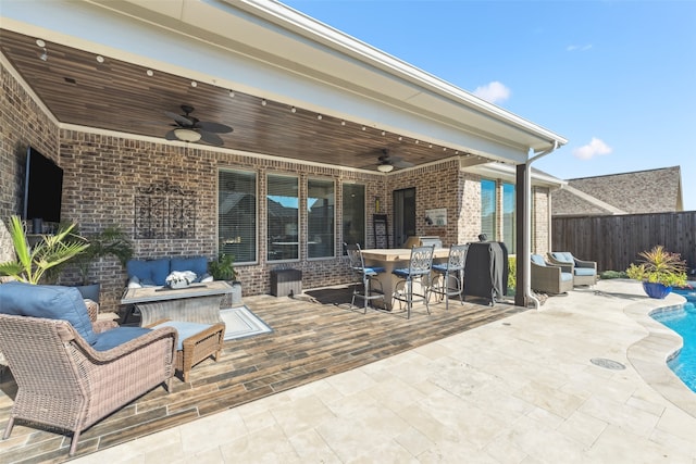 view of patio with outdoor dining space, an outdoor living space, fence, and a fenced in pool