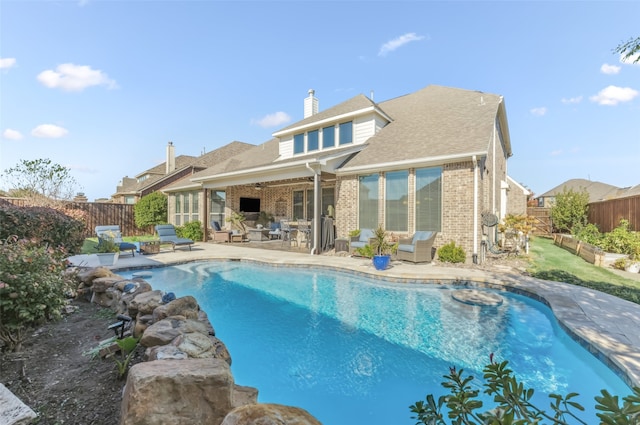 view of swimming pool featuring a patio area, a fenced in pool, a ceiling fan, and a fenced backyard