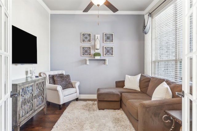 living room with a ceiling fan, crown molding, dark wood-style floors, and baseboards