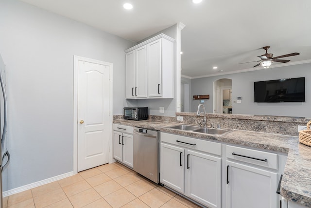 kitchen with a ceiling fan, a sink, stainless steel dishwasher, arched walkways, and light tile patterned floors