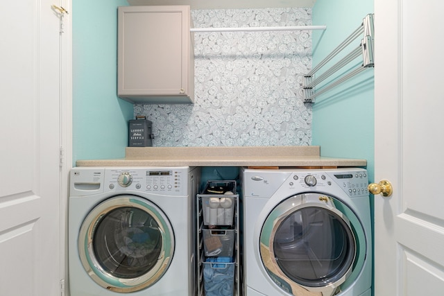 laundry area featuring cabinet space and separate washer and dryer