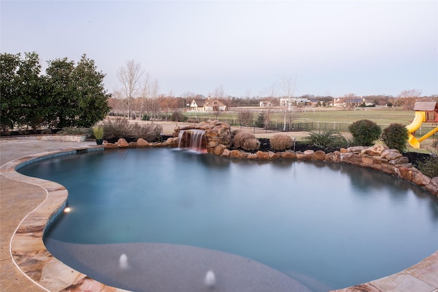 view of swimming pool with fence