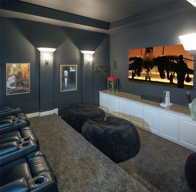 carpeted cinema room featuring baseboards