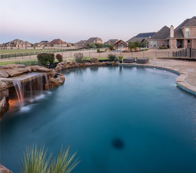 view of pool featuring a fenced in pool, a residential view, and a fenced backyard