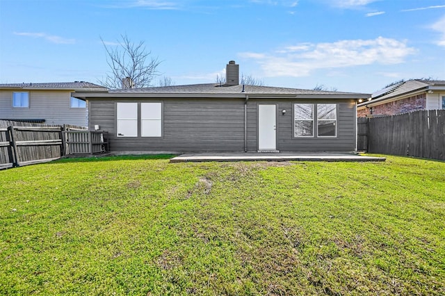 back of house with a lawn, a patio, and a fenced backyard