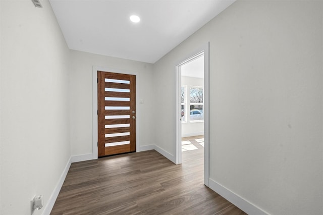 foyer featuring baseboards and dark wood finished floors